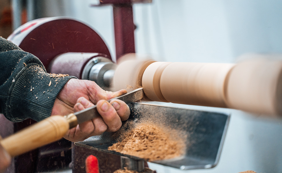 hands carving wood